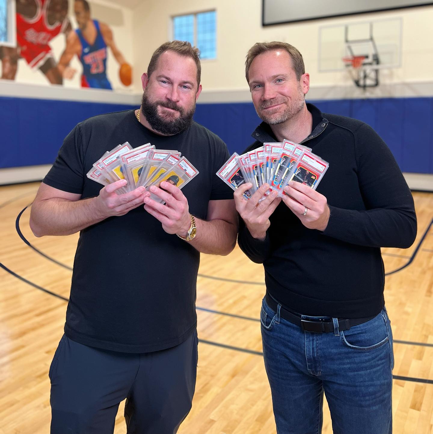 Collector Jason Koonce (left) shows off his sports card collection with Sports Card Investor Geoff Wilson. 