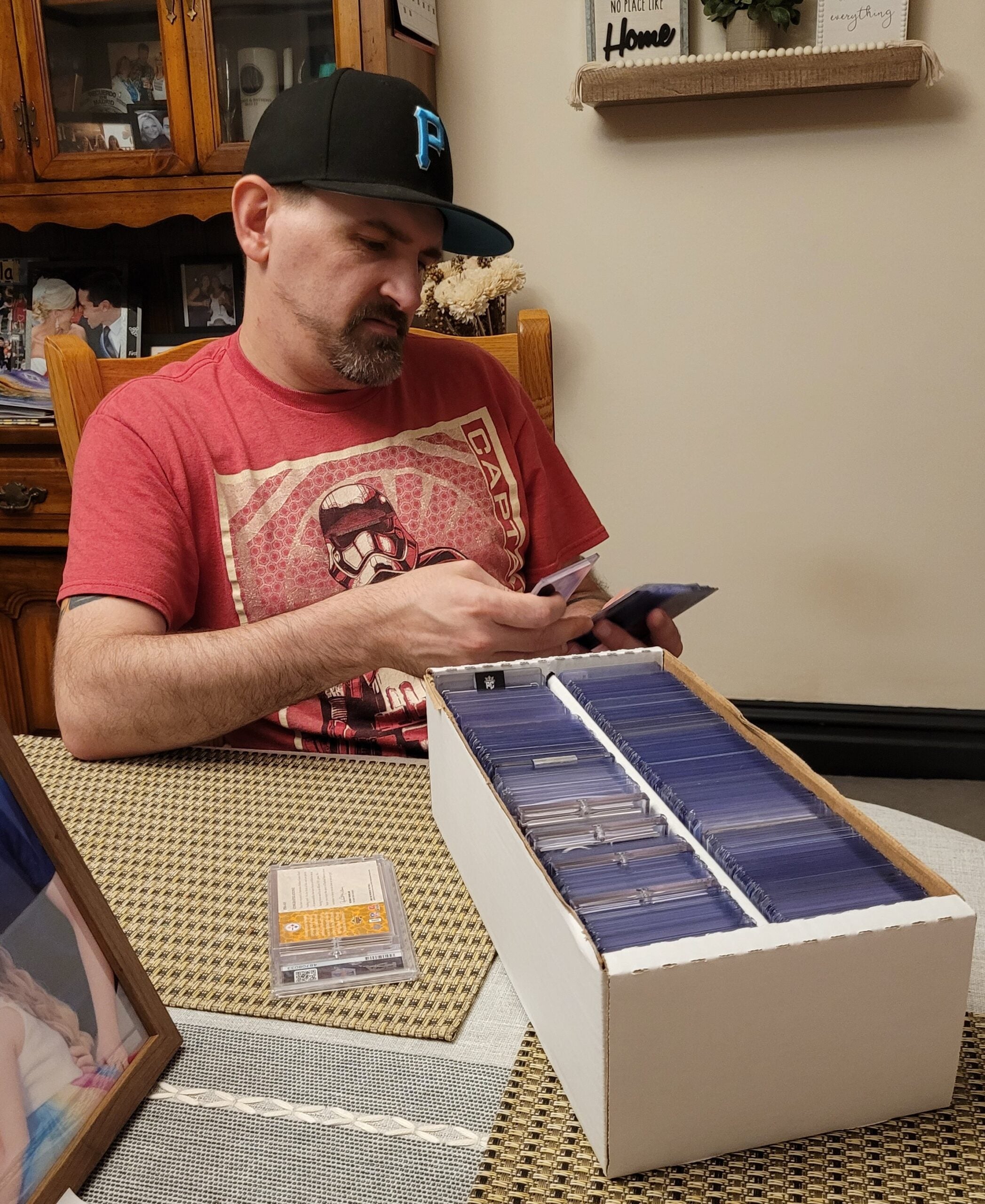 Collector and barber Neil Bowman goes through friend Tony Reid's sports card collection. 