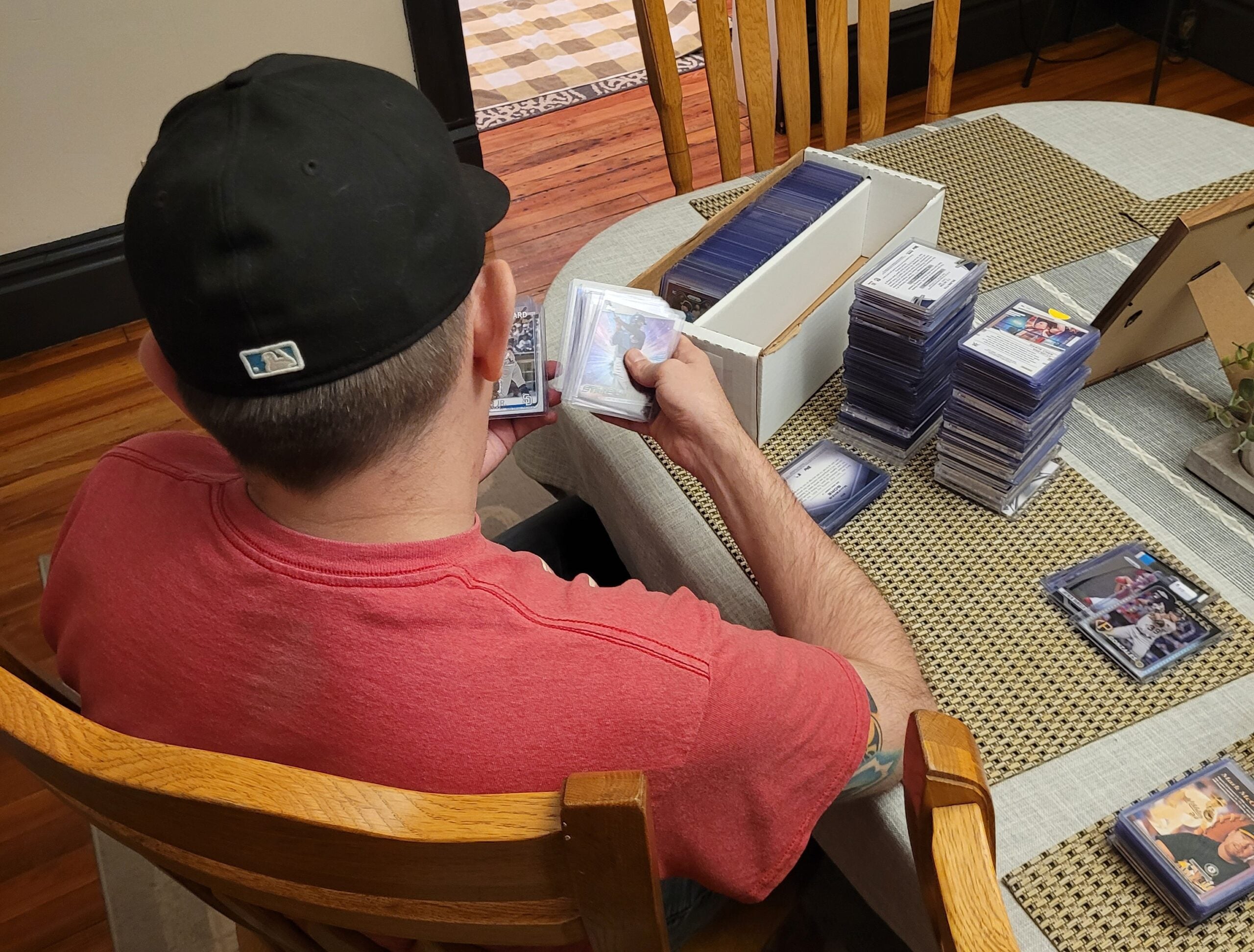 Collector and barber Neil Bowman checks out Tony Reid's card collection. 