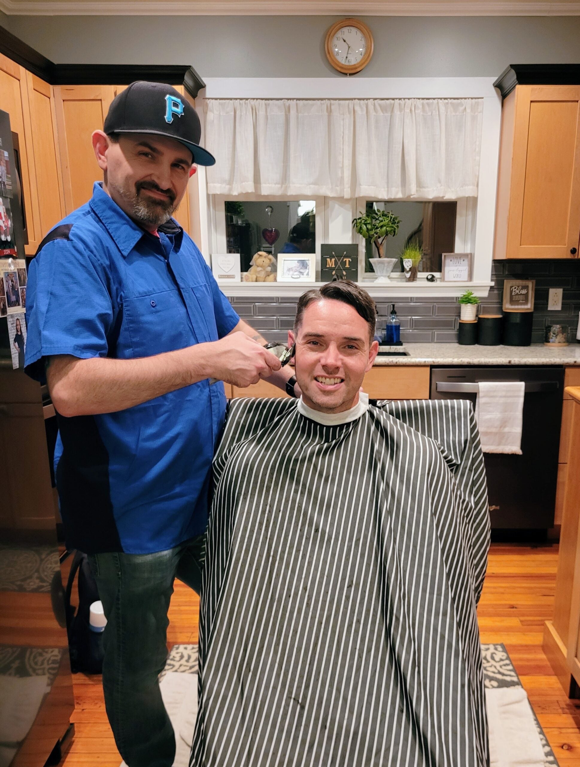 Tony Reid gets a haircut from his barber and fellow sports card collector Neil Bowman. 