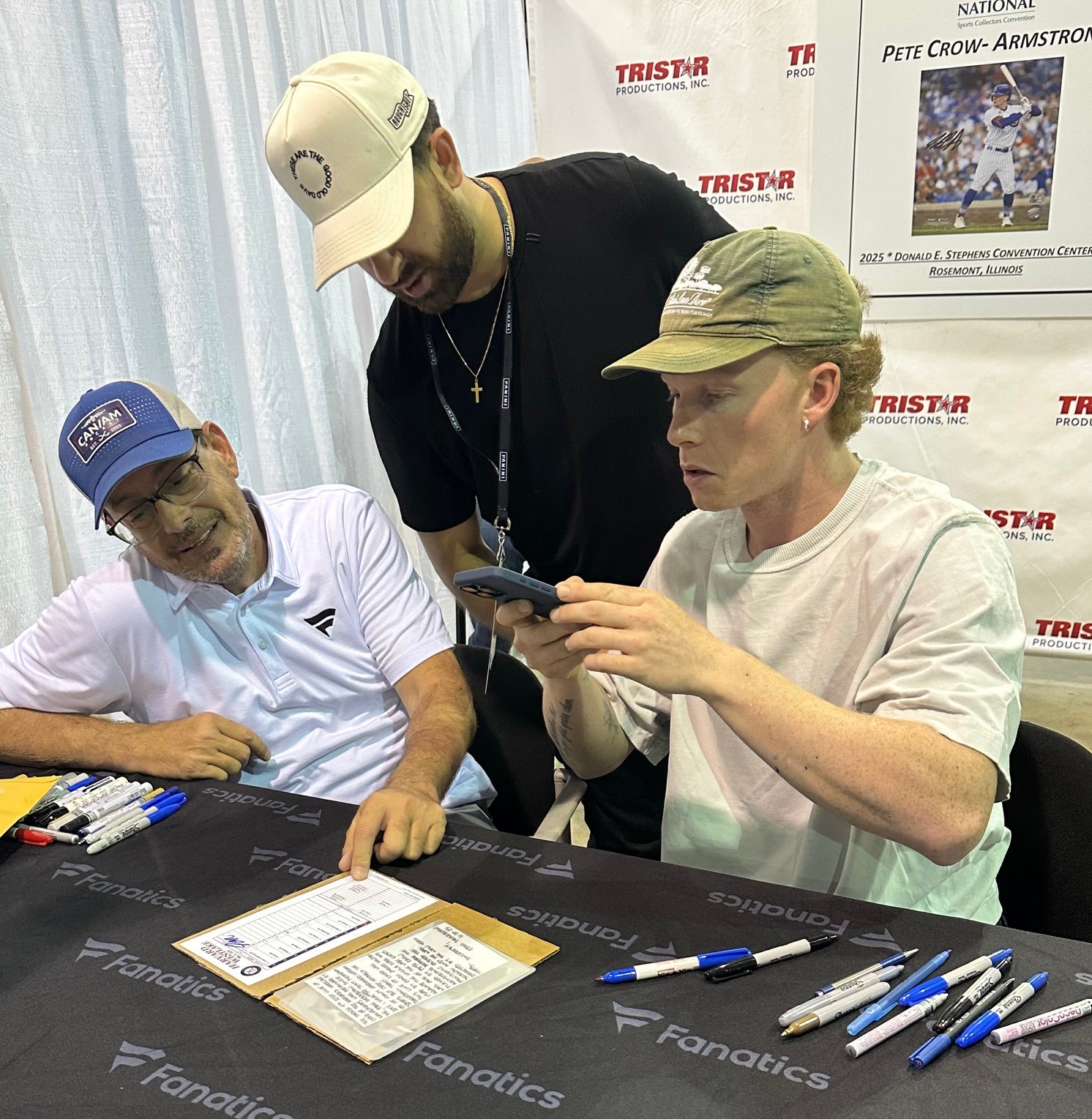Cubs star Pete Crow-Armstrong takes a photo of his high school line-up card, which he signed for a collector. 