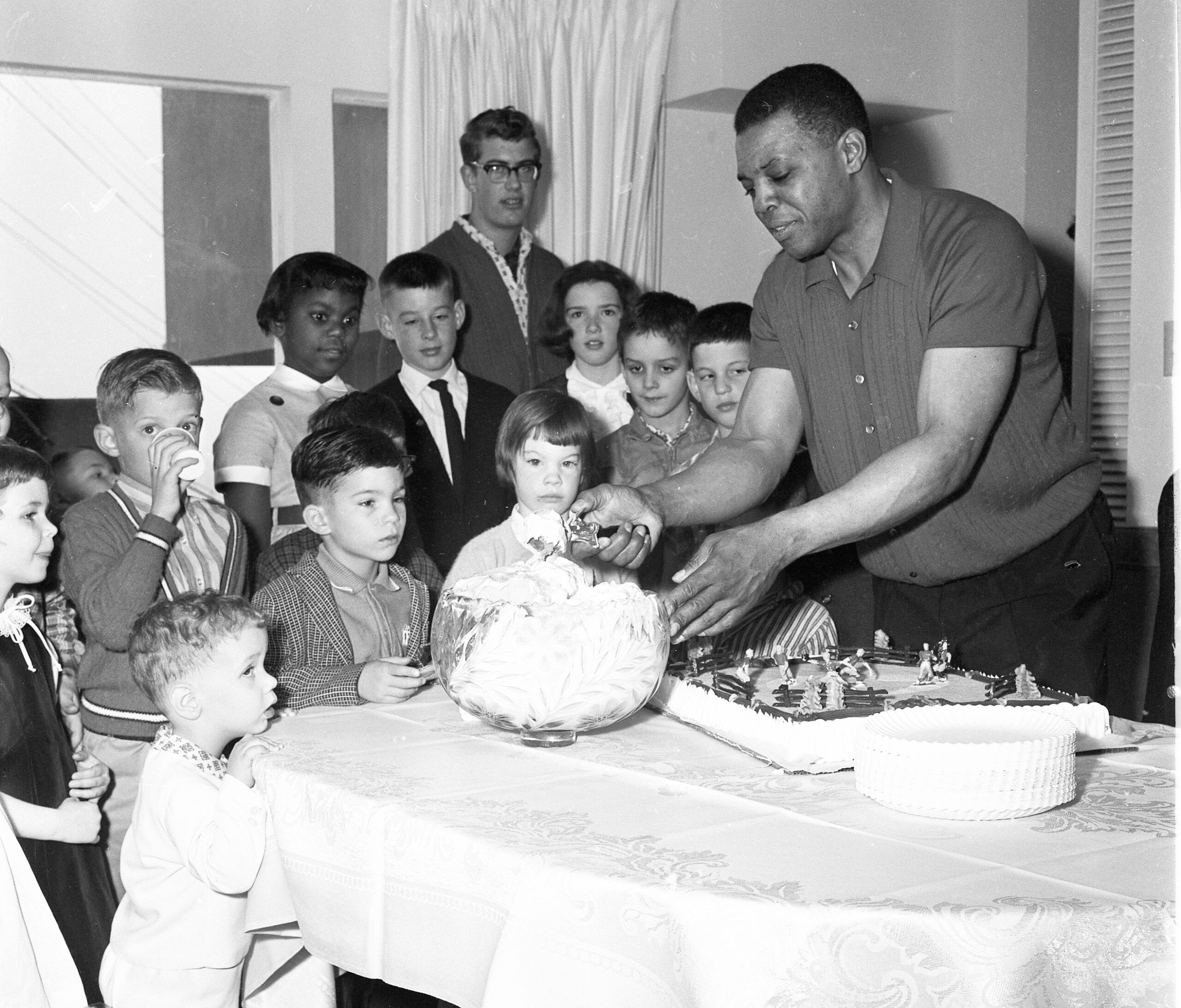 Willie Mays serves ice cream during a party for children at his San Francisco home in 1963. 