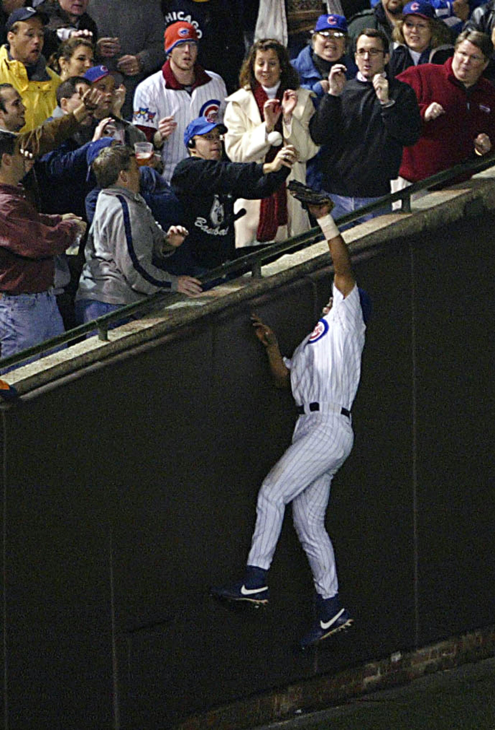 Cubs fan Steve Bartman interferes with Chicago outfielder Moises Alou during Game 6 of the 2003 NLCS on Oct. 14, 2003 at Wrigley Field. 
