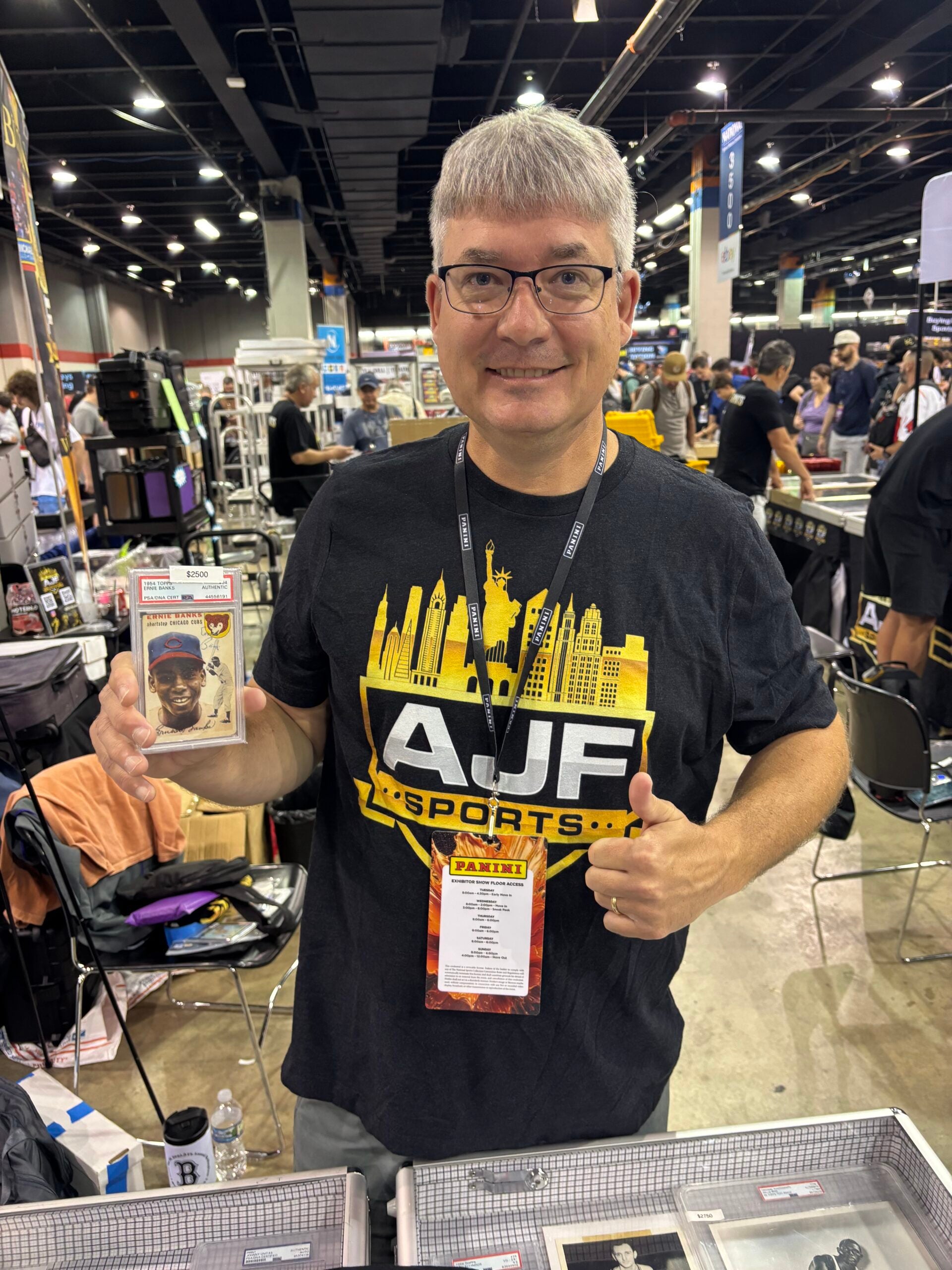 Jim Doyle of AJF Sports Cards with an Ernie Banks rookie card at The National. 