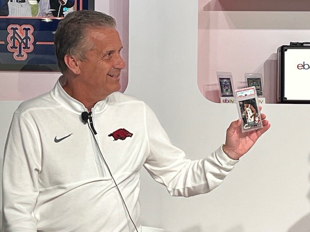 College basketball legend John Calipari shows off a card of Steph Curry at The National. 