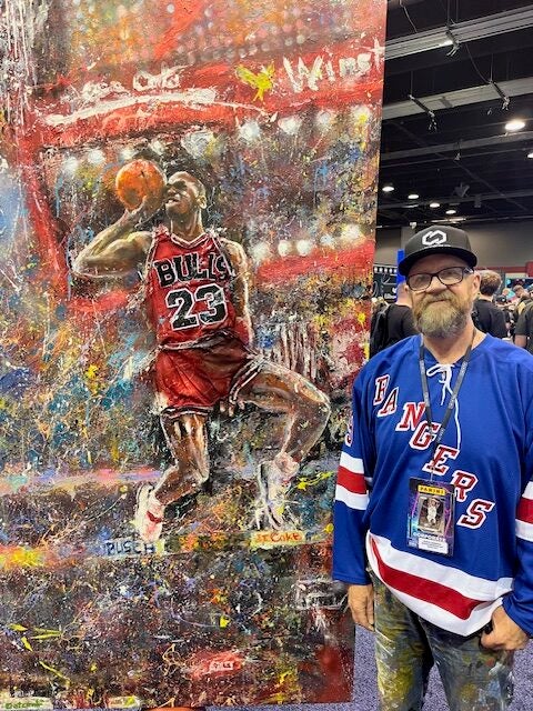 Artist Murray Henderson with a new Michael Jordan painting at The National. 