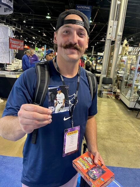 Minor league baseball player Jordan Powell from Celebration, Fla. gave a young collector a baseball glove and one of his cards at The National. 