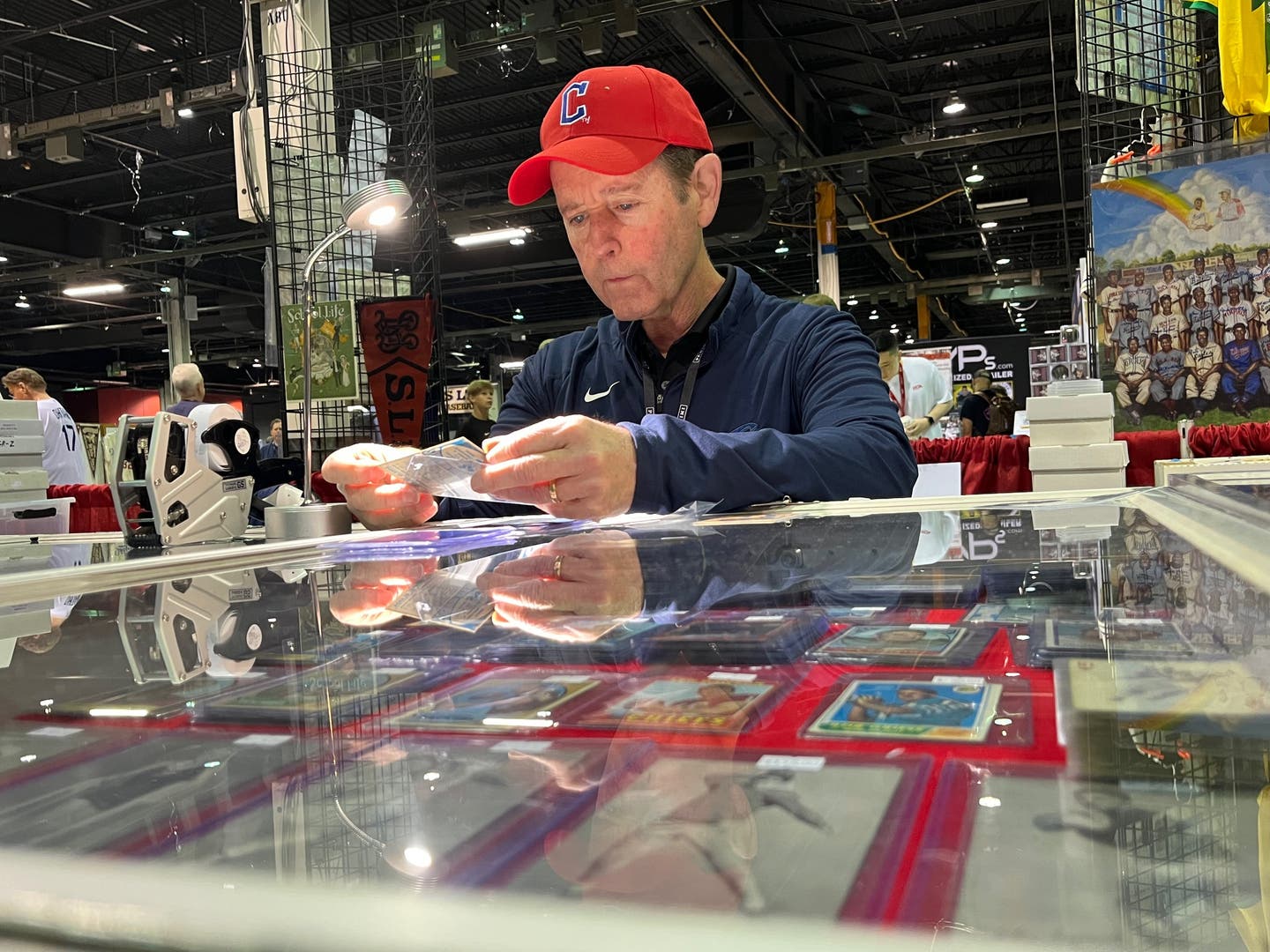 Kevin Savage of Kevin Savage cards examines a card at The National.