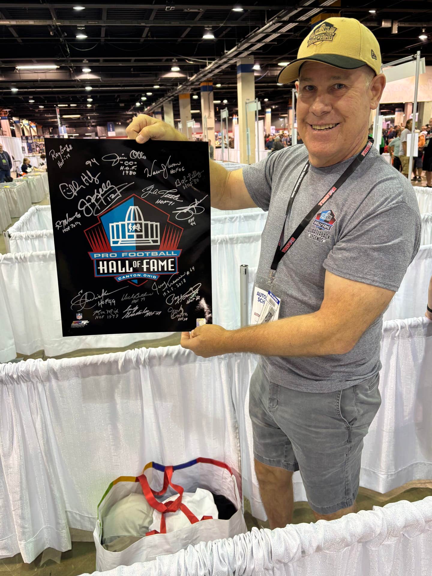 A collector shows off his signed Pro Football Hall of Fame poster at The National.