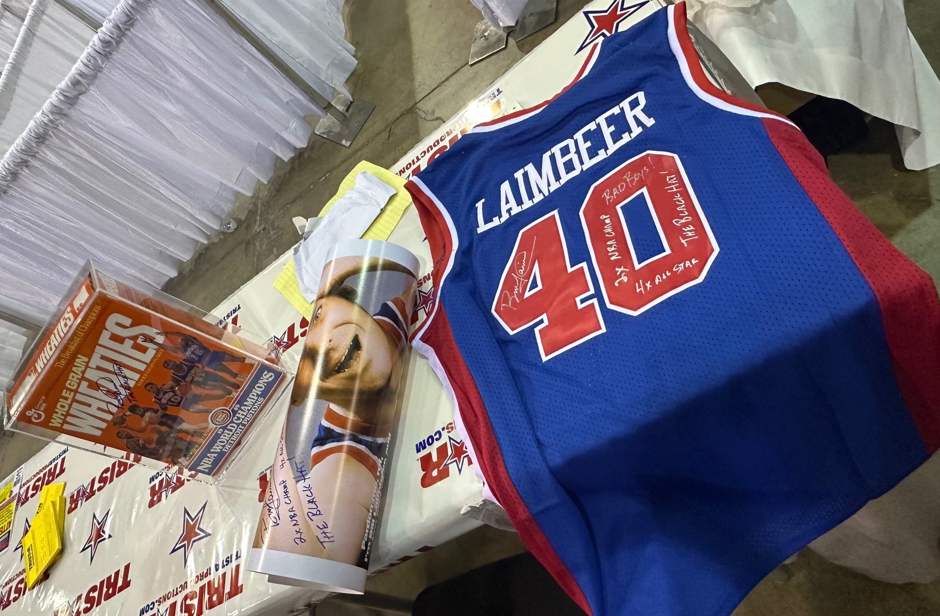 A Wheaties box, poster and jersey signed by Bill Laimbeer. 