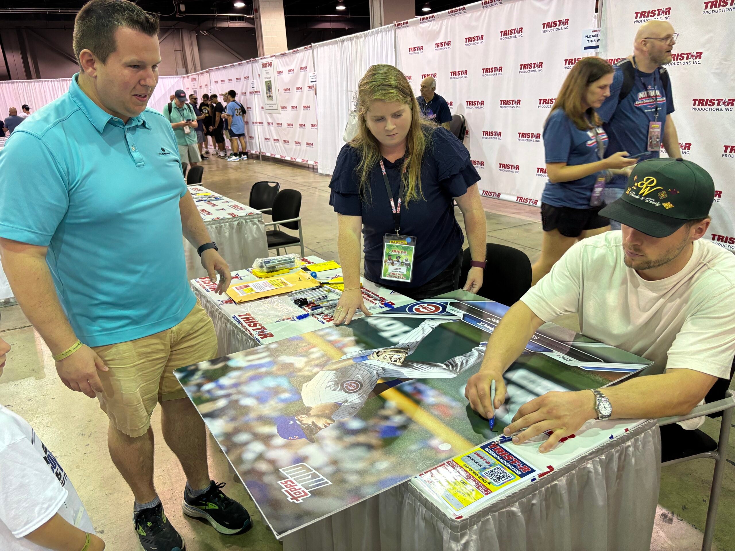 Ryan Mroz presented Nico Hoerner with a giant baseball card of the Chicago Cubs infielder for him to sign. 