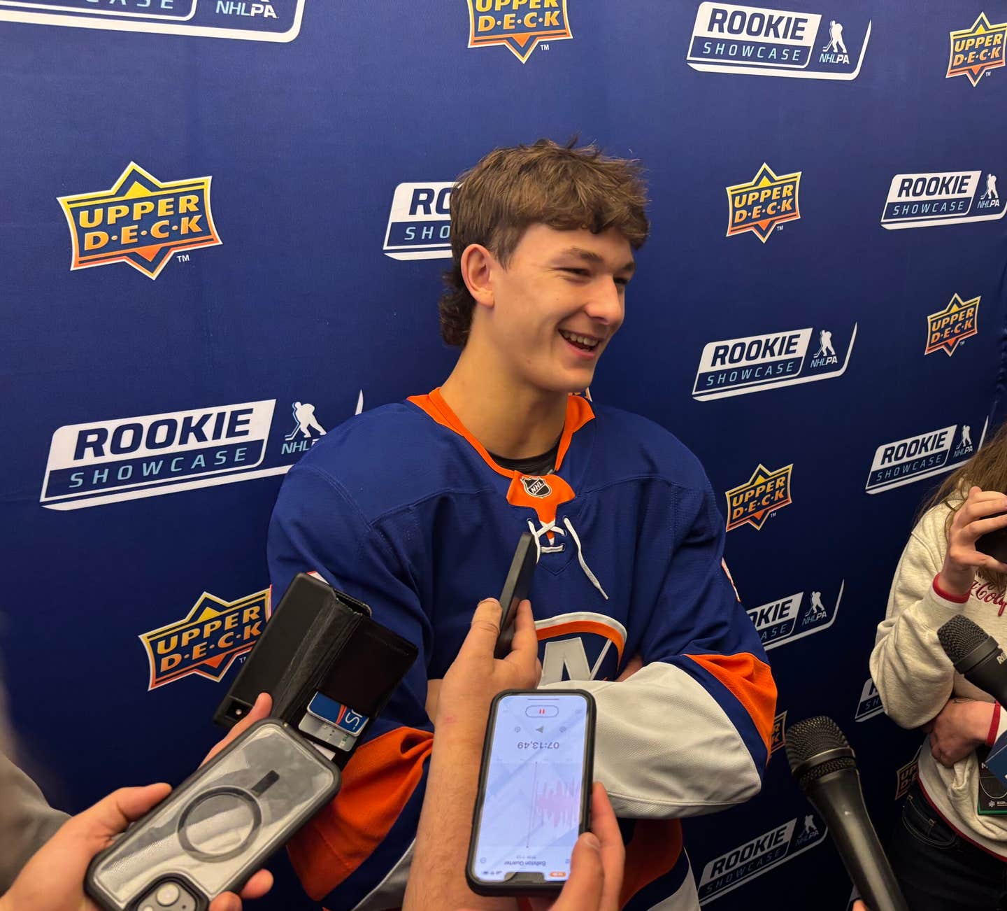 Matthew Schaefer jokes with reporters during the 2025 Upper Deck NHLPA Rookie Showcase.