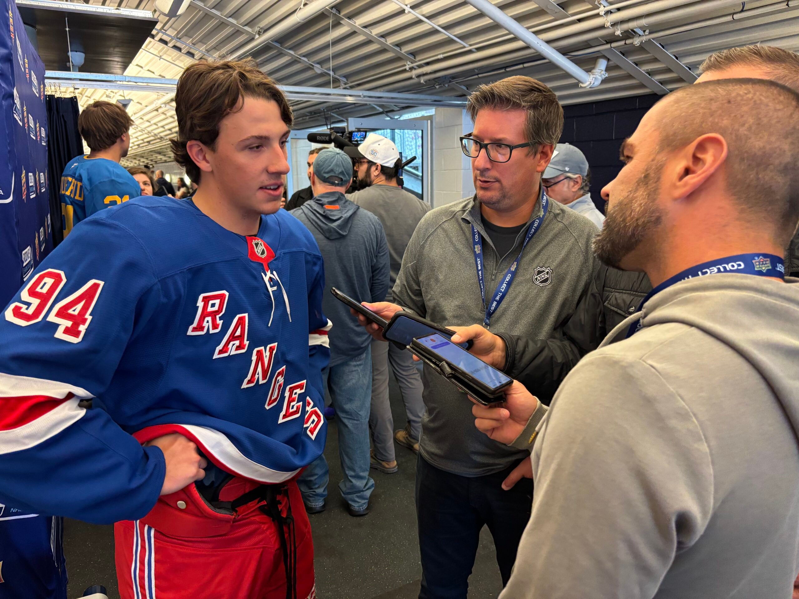 Gabe Perreault fields questions in French from a group of reporters at the 2025 Upper Deck NHLPA Rookie Showcase.