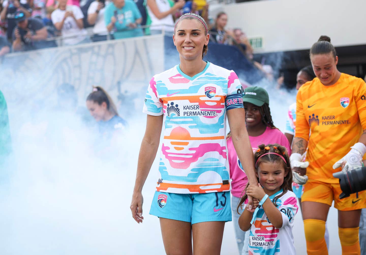 Alex Morgan walks out with her daughter, Charlie, before a game at Snapdragon Stadium in San Diego in 2024.