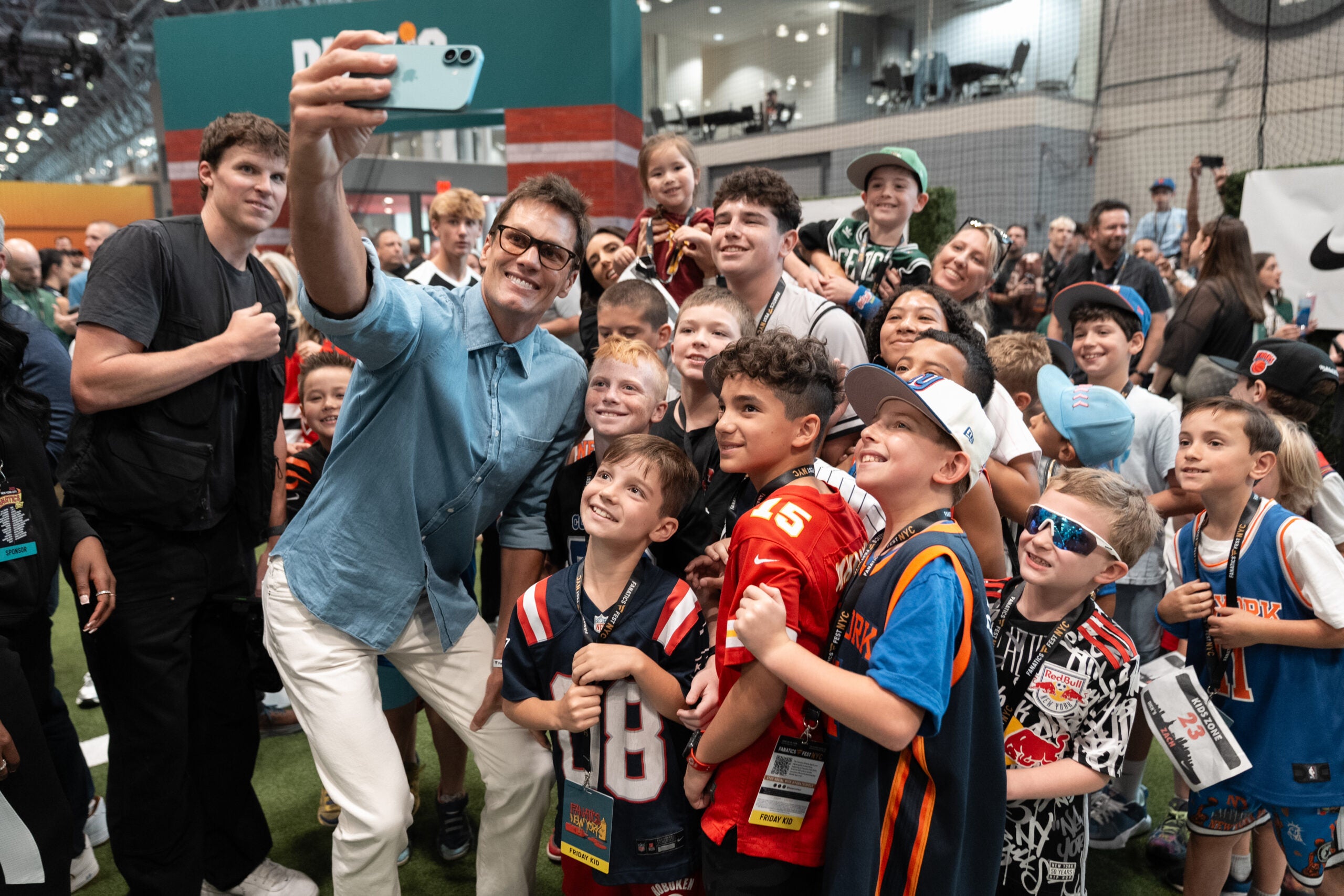 Tom Brady with young fans at Fanatics Fest 2025. 