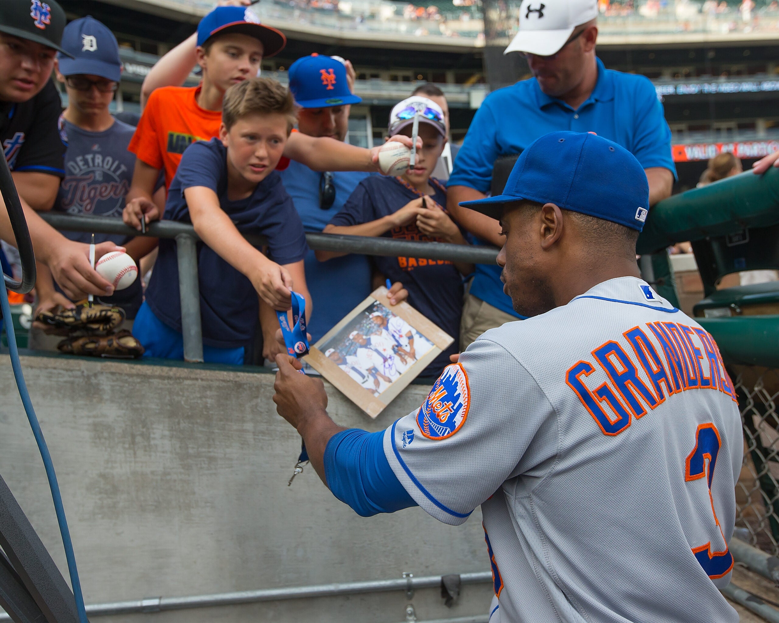 Curtis Granderson of the Mets signs autographs in his return to Comerica Park in 2016.  