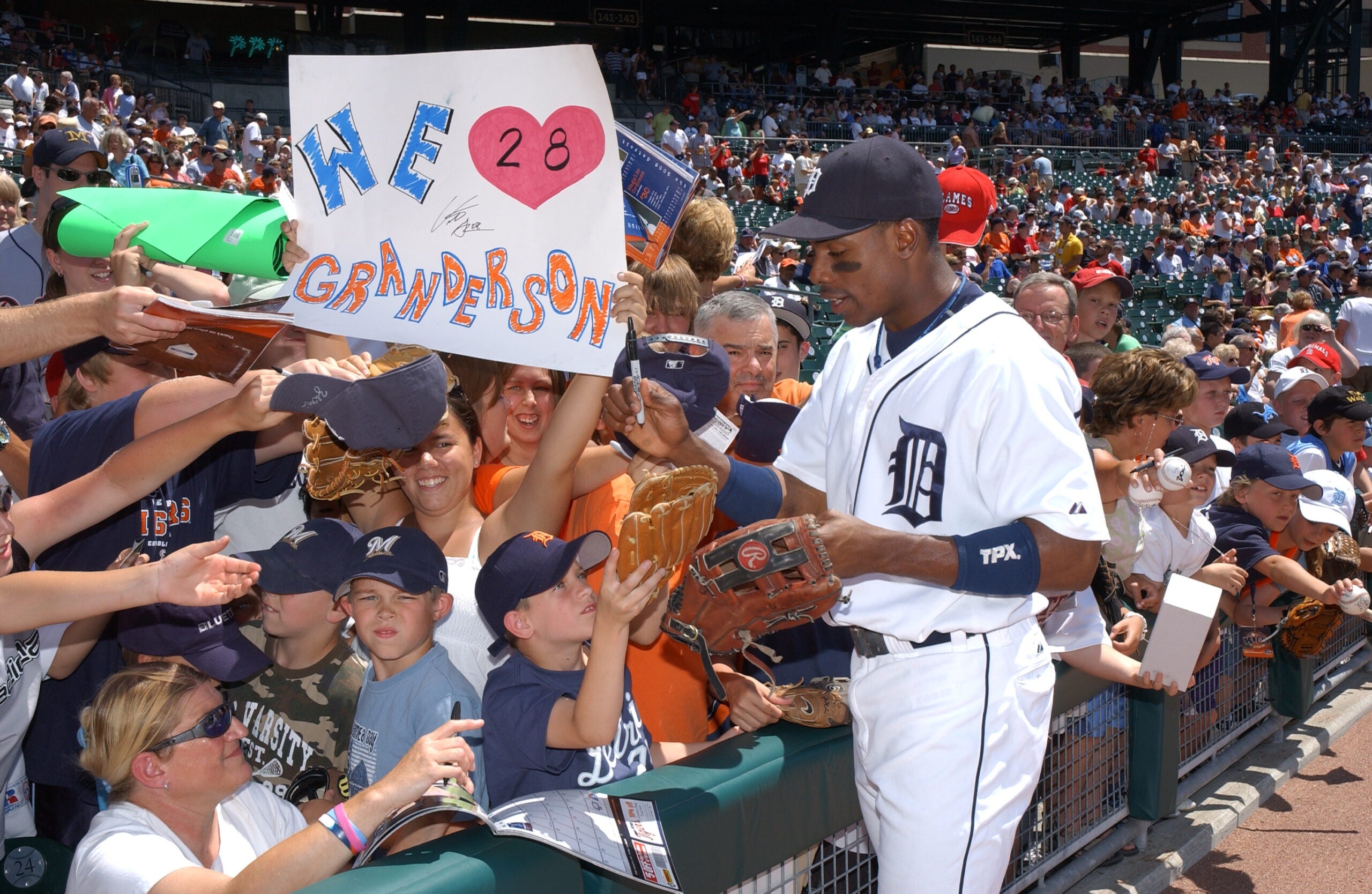 Curtis Granderson signs autographs for Tigers at Comerica Park in Detroit in 2006. 