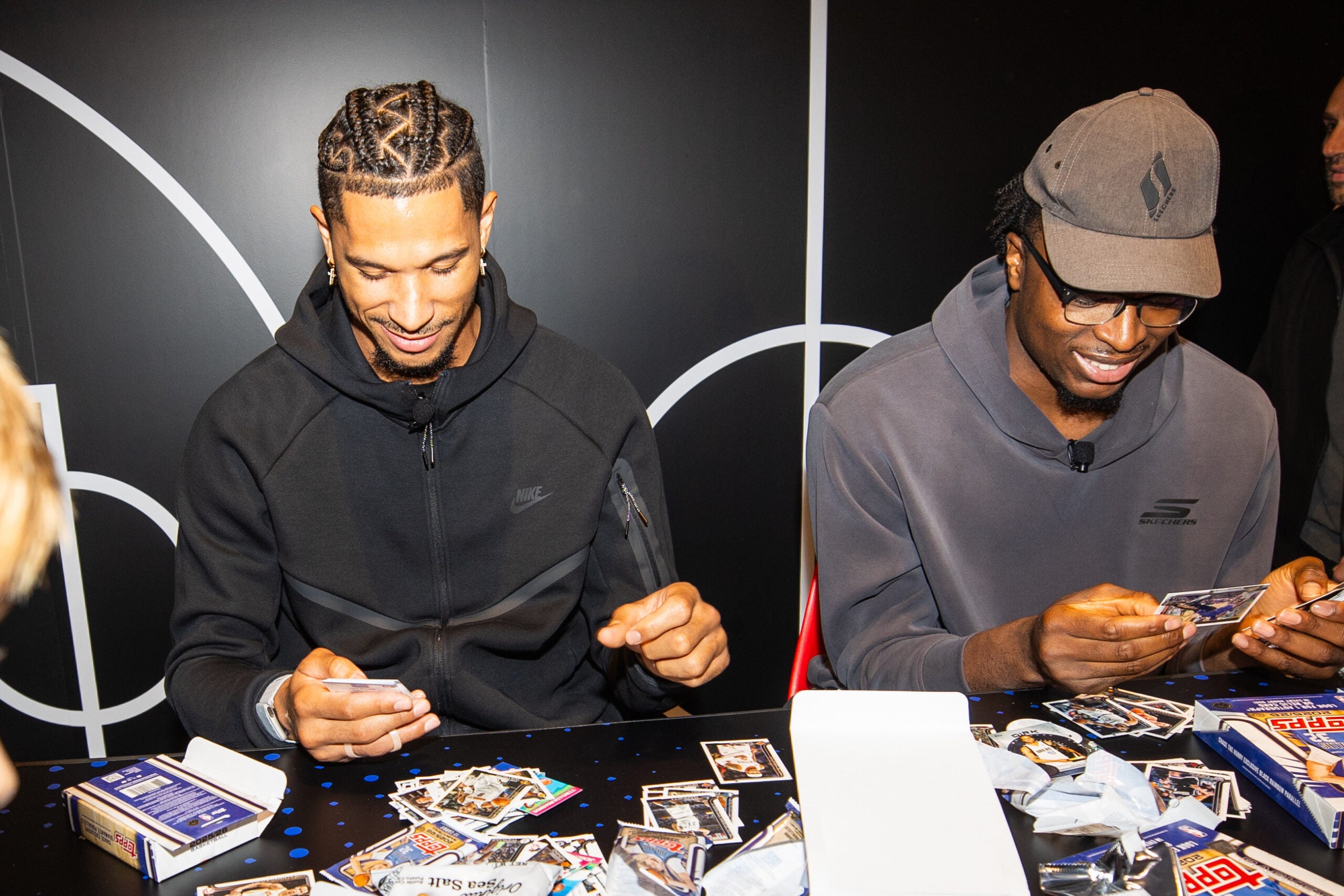 Knicks stars Jason Hart and OG Anunoby rip packs of cards at the Topps Basketball launch party in NYC. 