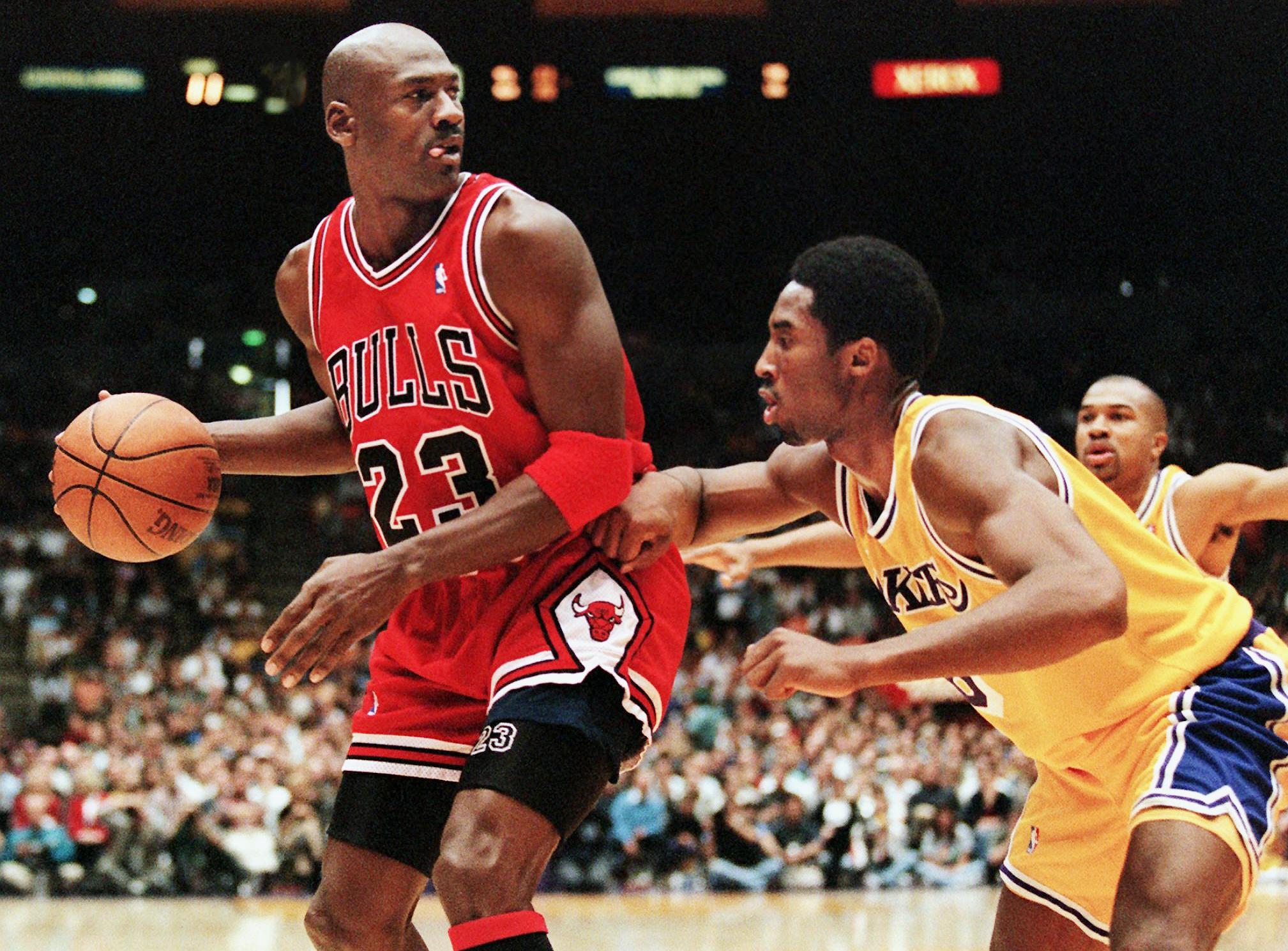 Michael Jordan is guarded by Kobe Bryant in a 1998 game in Los Angeles. 