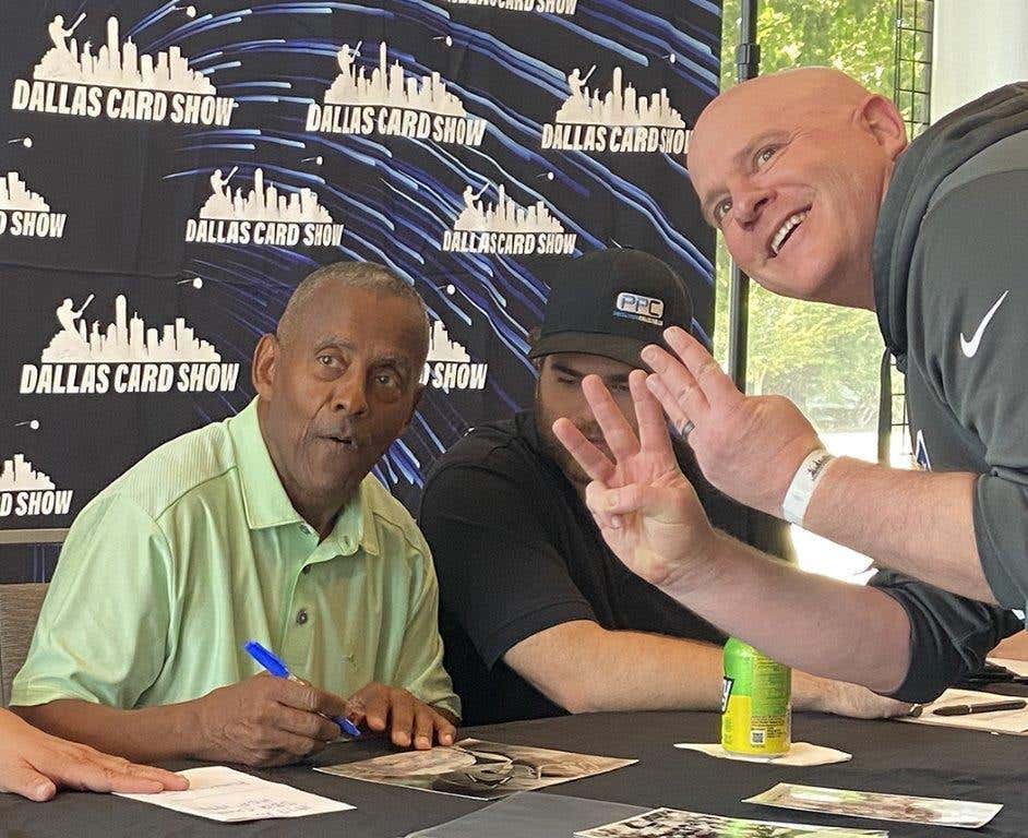 Dallas Cowboys legend Tony Dorsett signs an autograph for a fan at the Dallas Card Show.